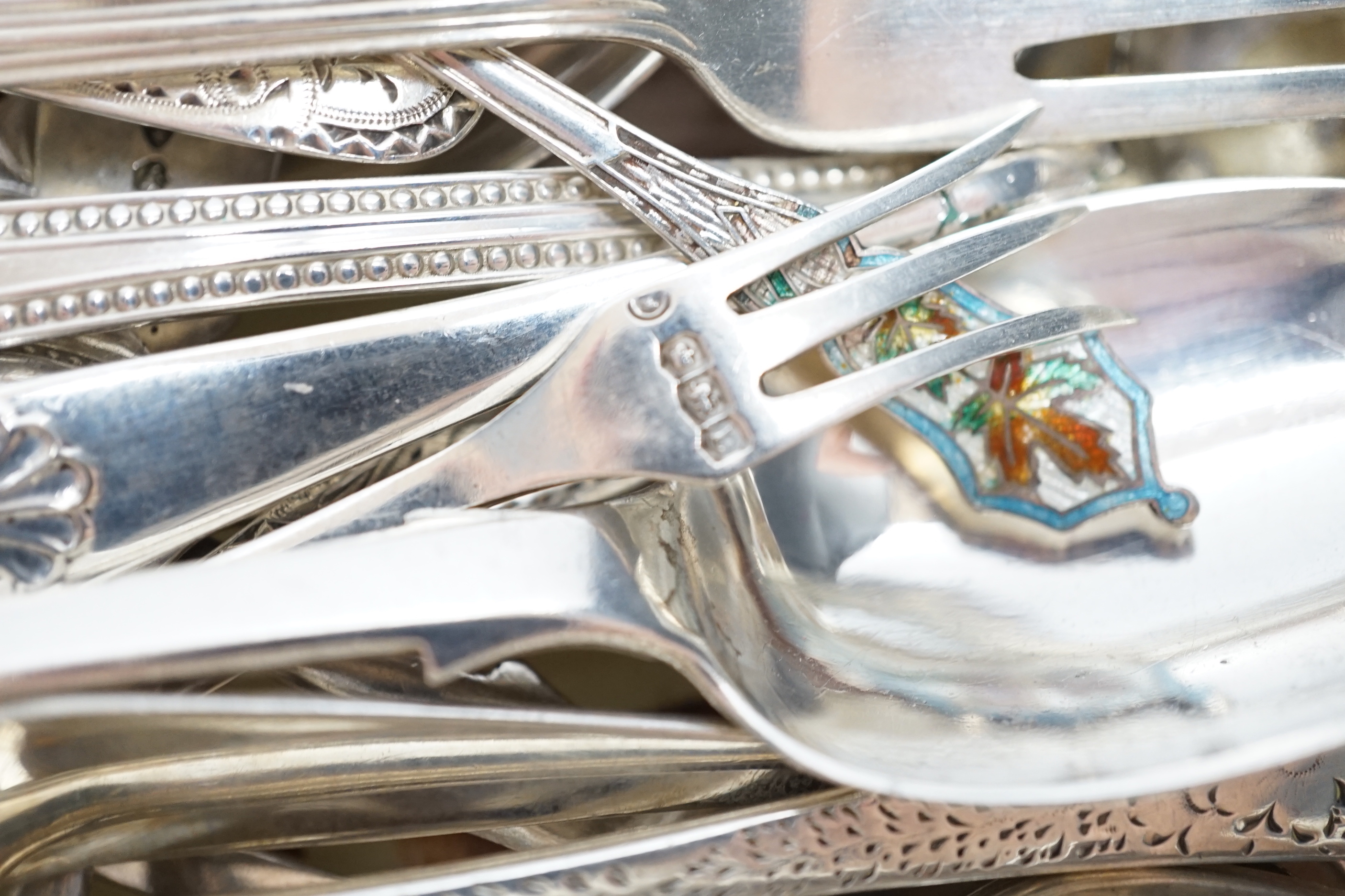 Sundry silver cutlery, including a butter knife, teaspoons, condiment spoons, sauce ladles, etc.